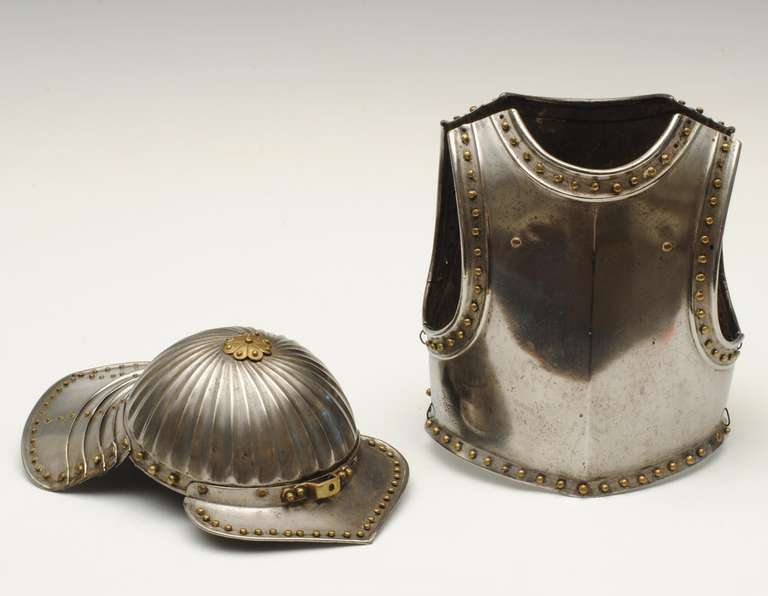 A miniature set of armor with a breast and back plate and a helmet with lobster tail back.