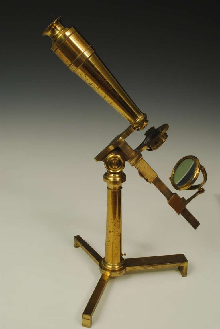 A fine and rare compound microscope by Ramsden , London in superb condition with the original mahogany box and a near complete set of Accessories.