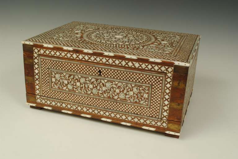 A suberb Indian writing box, the inlaid decoration of the finest quality. The interior fully fitted and with a very unusual fall front with three small drawers accross the botttom. This type of box was made in Hoshiarpur.