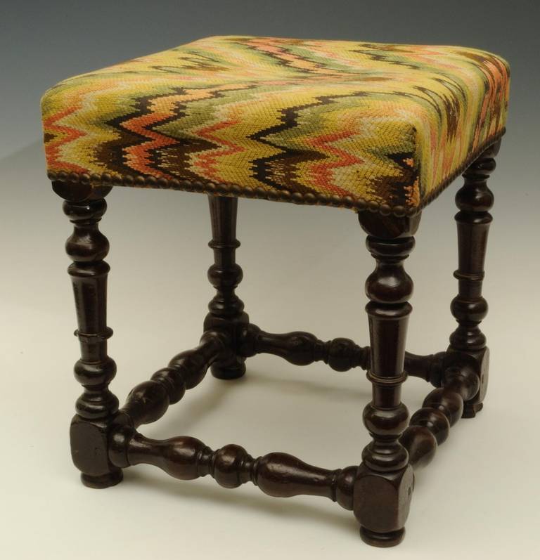 A charming late 17th century walnut stool.