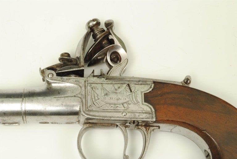 A good pair of 18th century boxlock pocket pistols by Bond London. The name engraved in a trophy of arms, and with walnut stocks.