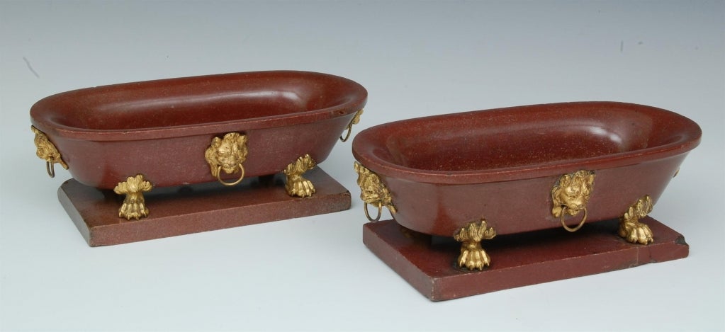 A pair of 18th century Roman red marble baths with original ormolu lion mask and hairy paw feet mounts.