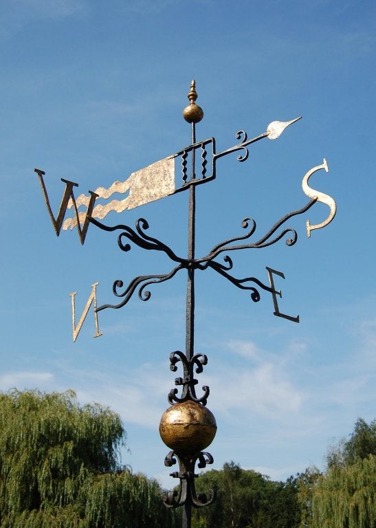 A rare late 17th century iron and copper weather vane with gilded letters and the pointer with a windy tail.