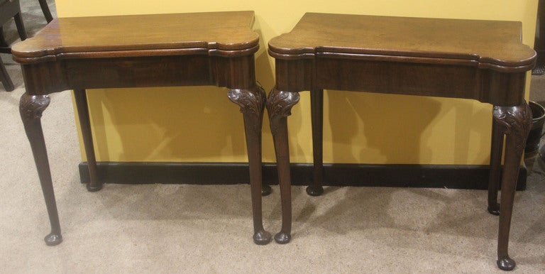 A pair of Georgian mahogany tables, one a card table the other a supper table. On cabriole legs with acanthus carving on the knees and pad feet. Circa 1770.