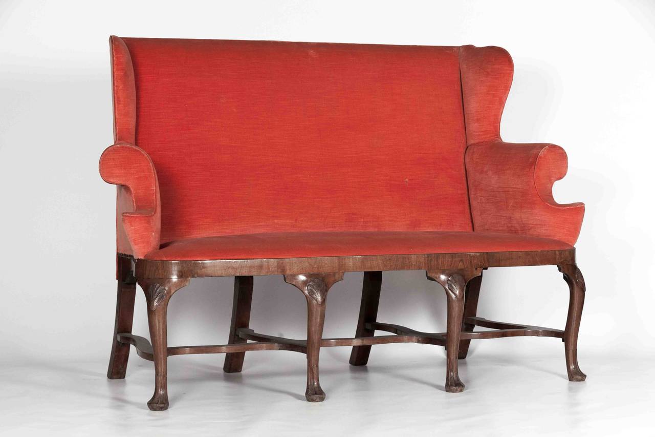 A very smart Irish Walnut Georgian Settee with cabriole legs, serpentine stretchers and shells on the knees. Illustrated in Irish Furniture by Desmond Fitzgerald and James Peill page 215 number 46.