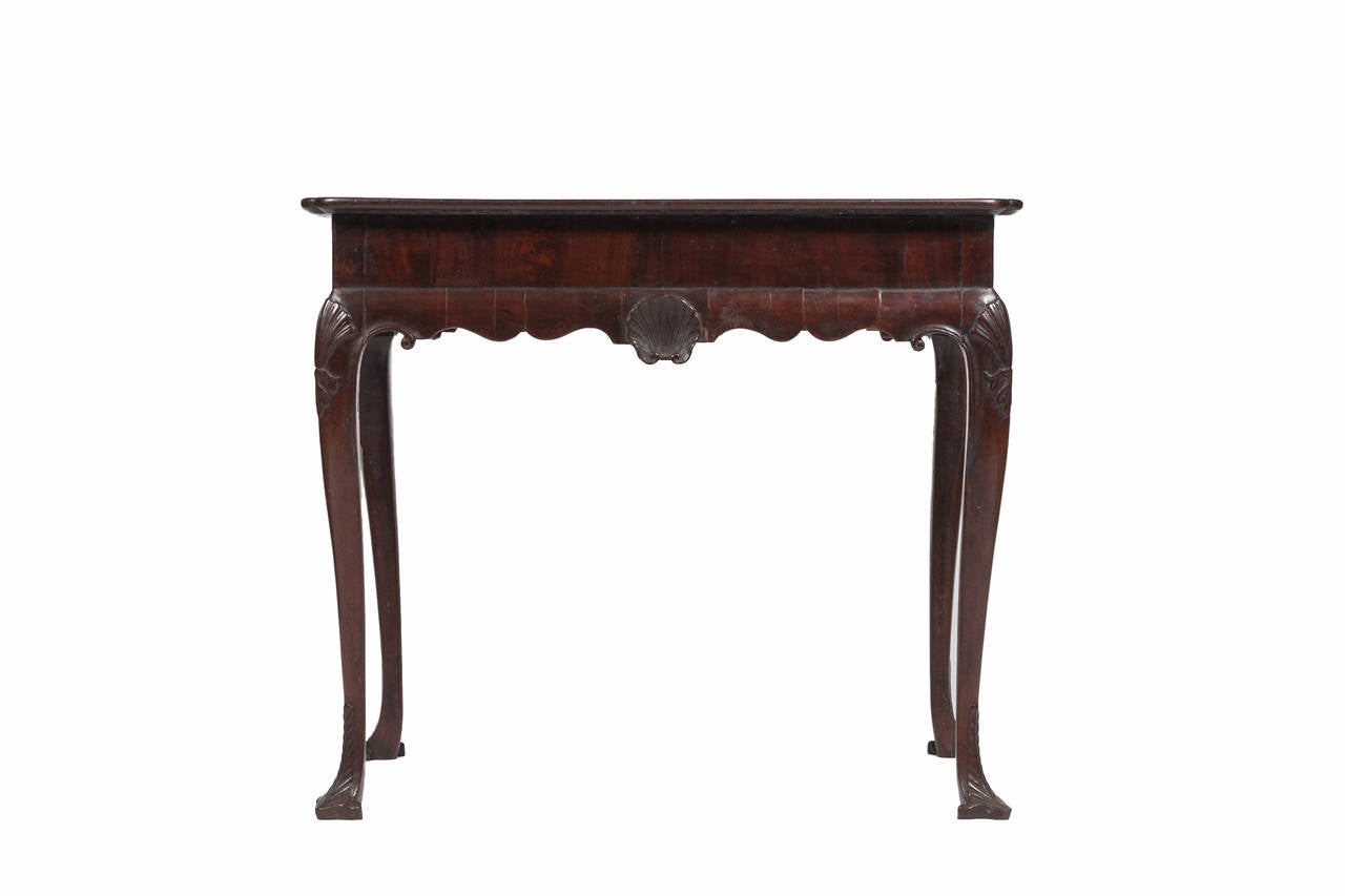 An Irish Mahogany cabriole leg silver table with carved Trifid feet. Circa 1740.