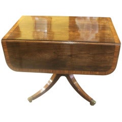 A Regency Mahogany and Rosewood Drop Leaf Table