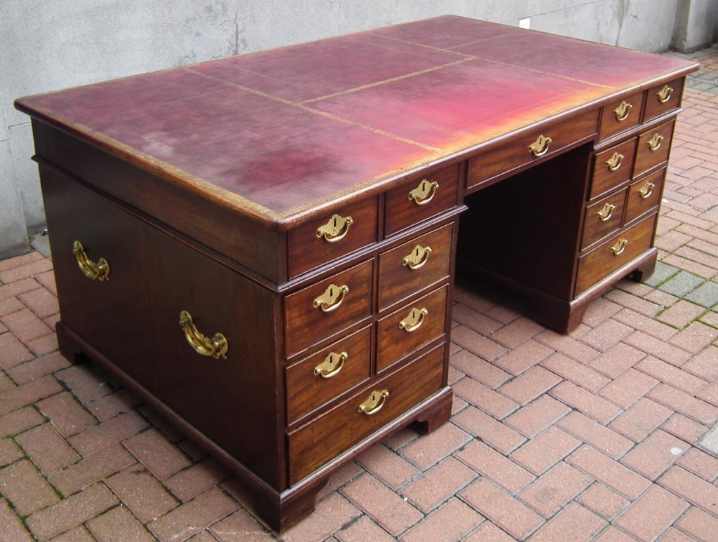 A Georgian mahogany double sided partner's desk with brass carrying handles on each side.
Height: 31