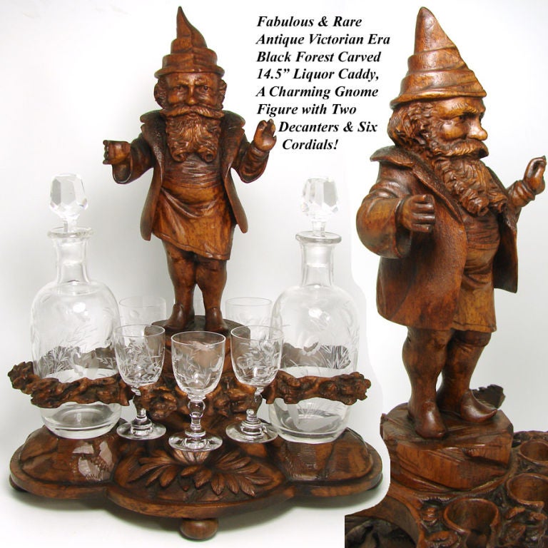 Spectacular & RARE antique Victorian era Black Forest hand carved liquor caddy or stand with delightful & large forest gnome figure, ornate foliate base and gorgeous intaglio etched 8pc decanter & cordial set! WOW! What a fantastic piece and rare,
