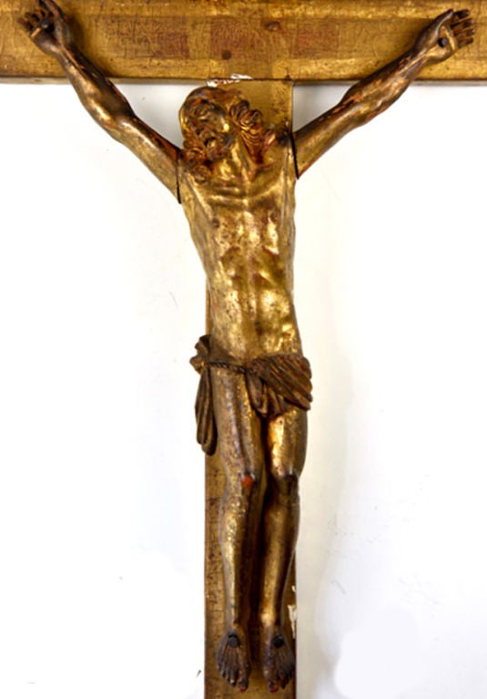 Magnificent and early hand carved wooden Christ, Crucifix, dating 1600s, the alter cross is gilted in gold leaf or 'pounded gold' with the typical underlayment of a rust-colored 'rouge' typical of the process. This would have been an alter cross in