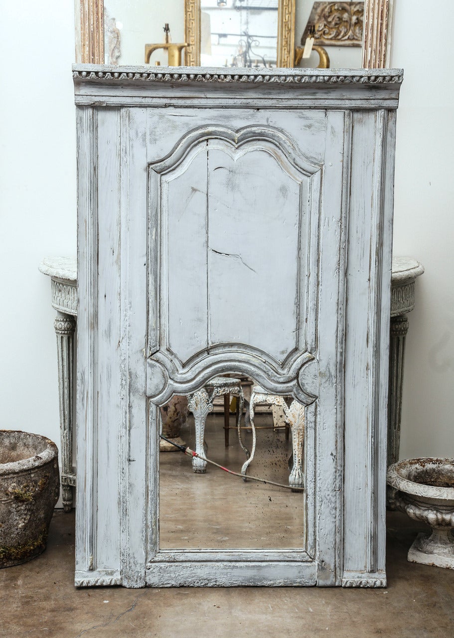 19th century fragments made into a trumeau mirror with antique mercury mirror. This mirror has been manufactured recently to look old.  From bottom of wood to top of mirror is 23
