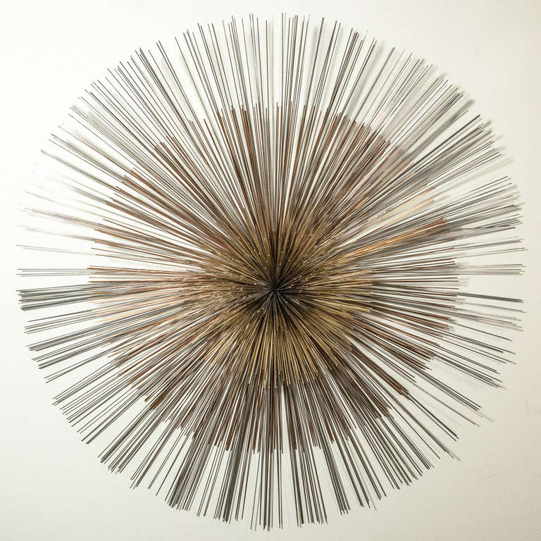 An Oversized Starburst Wall Sculpture by Curtis Jere. Brass and Chrome Detail.