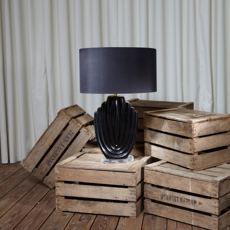 A single black ceramic table lamp on a lucite ribbed base.
Rewired to English standards. New silk cord. 
Shade not included. Shades can be made to order.