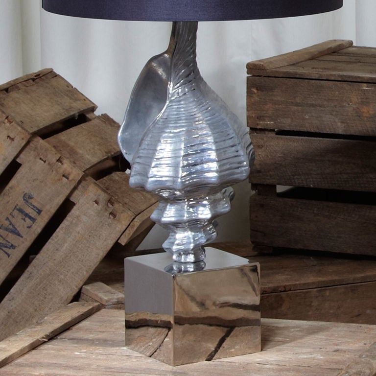 A single sculptural table lamp. Polished aluminium conch shell on a polished cube base.
Rewired to English standards. New silk cord. Shade not included. Shade can be made to order
Shade not included. Shade can be made to order.