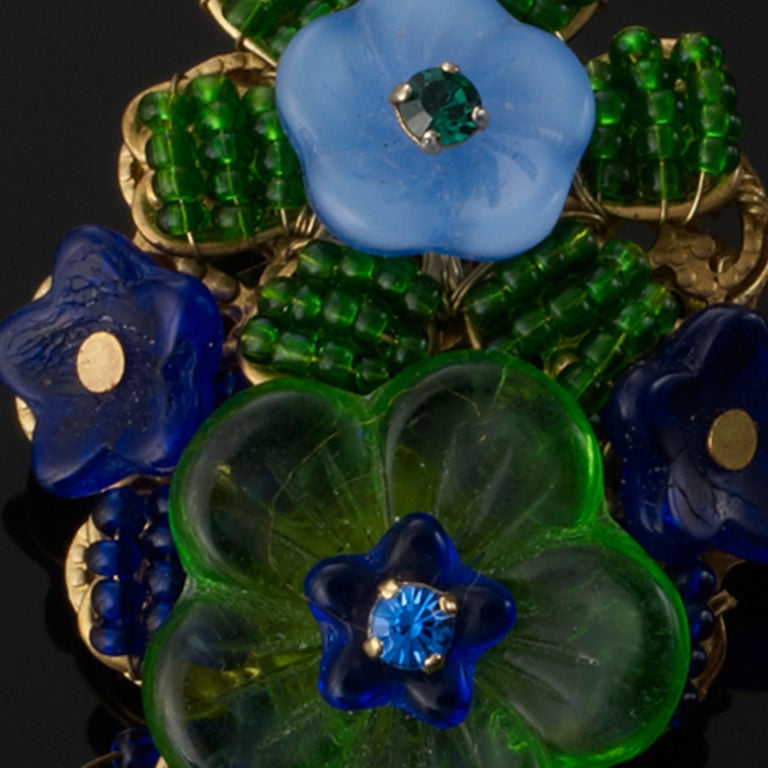 A pair of 1970's Stanley Hagler green & blue multi beaded flower earrings. Clip on back.