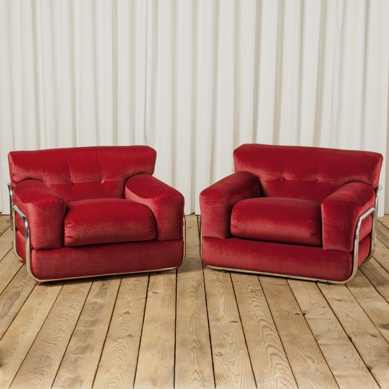 Wonderful statement pair of 1970's lounge chairs newly reupholstered in bright red velvet with a highly polished chrome frame.