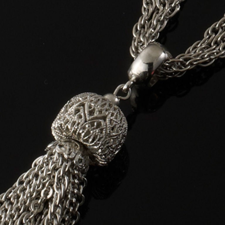 A truly stunning piece on, this necklace has a choker draped effect at the neck which then falls into a tassle pendant.