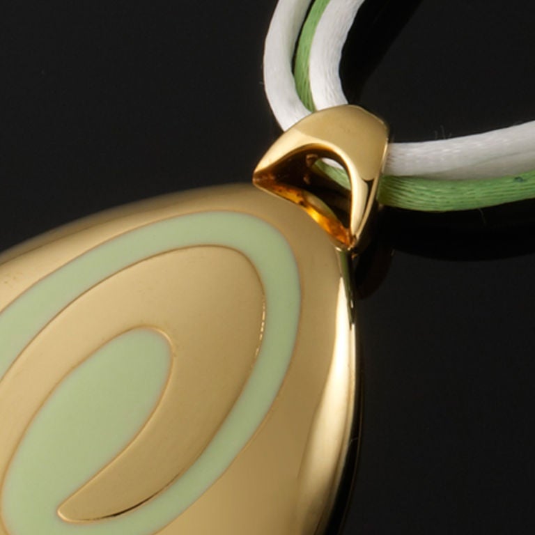 A gorgeous Gold and Mint Green pendant on 3 silk ropes with Gold clasp
Signed on the back of pendant