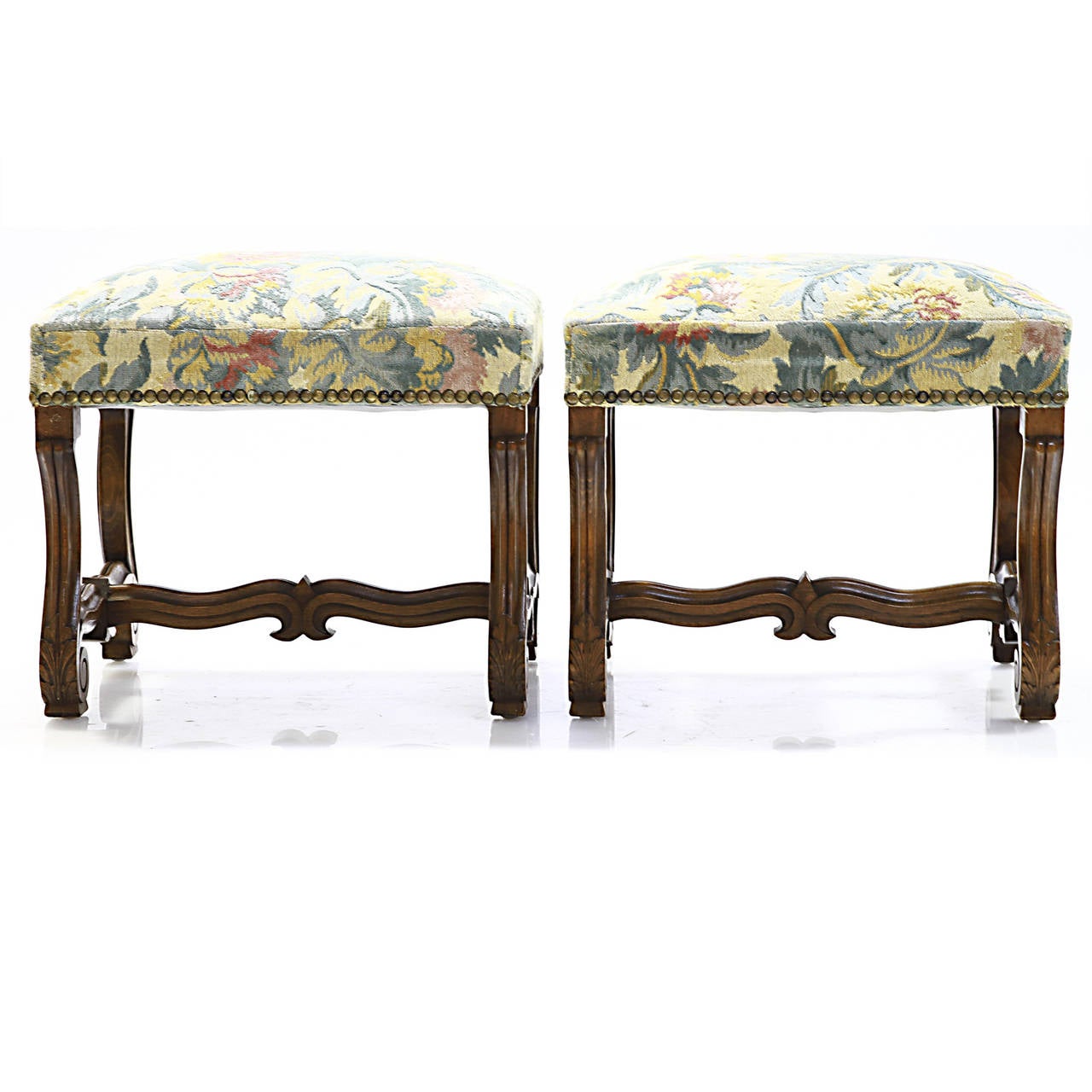 A fine pair of Louis XIV walnut tabouret's resting on a reed console shaped legs. There is a H-stretcher with the center support having a fleur-de-lis design. Very sturdy and freshly waxed patina.