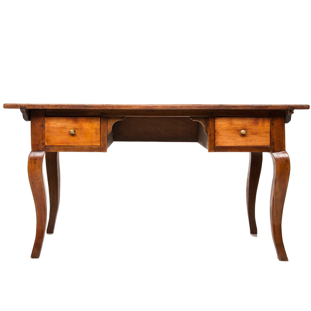 An early 19th century French Provincial bureau plat, having one drawer. This writing table has a warm brown and honey, worn oak color. The apron slightly shaped and having the one drawer with a Rococo pull. There are four cabriole legs with carved