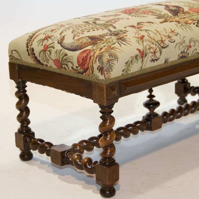 A Louis XIV walnut stool with a twist leg and stretcher. Front side is have raised moldings. Excellent condition and new upholstery. Very sound piece.