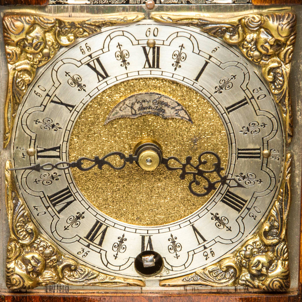 This beautiful walnut bracket clock with a moonphase/calendar. This clock strikes the half hour and the full hour, the case is in beautiful condition. All decoration is brass from the feet to the handle. The Dial has beautiful engravings and signed