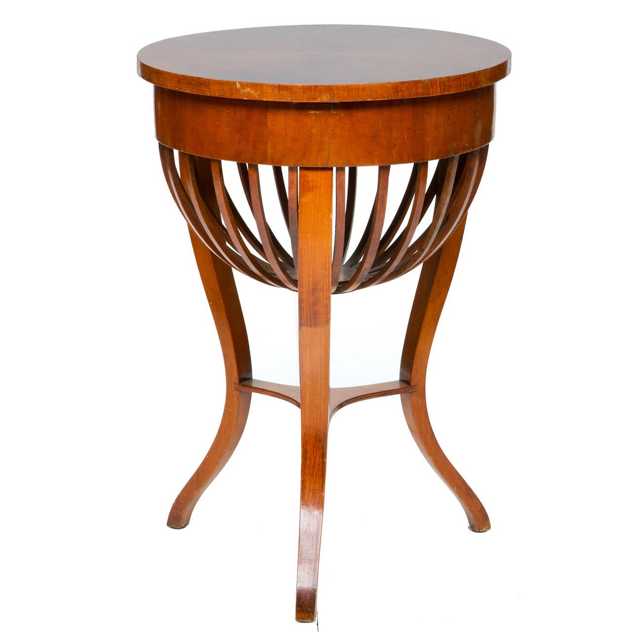 An unusual Italian work table with lift top revealing a fitted interior. The round top would make a functional side table with the basket undercarriage giving a unique look. Made of walnut and a wonderful patina this table is a unique find. The