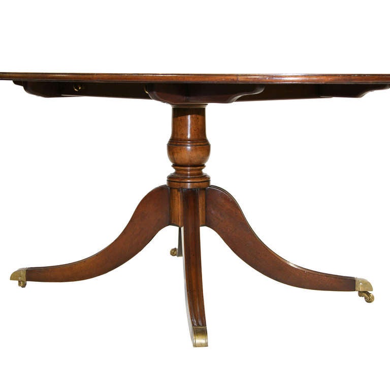 This table was made by a prestigious English cabinetmaker named Restall Brown of London. The table is made with mahogany and banded with burl yew wood, tulip wood, and Satinwood. This is from a local estate well maintained. Rest upon one single