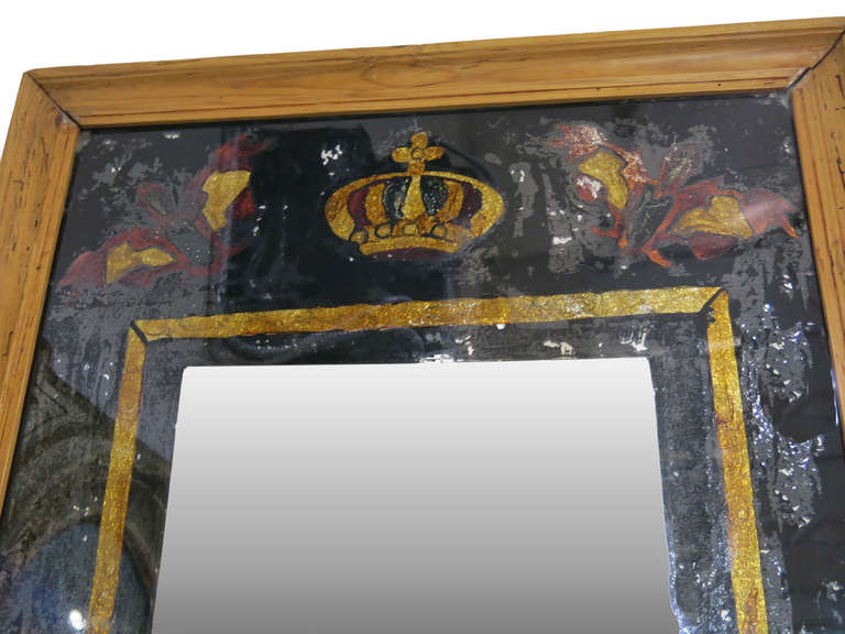 19th Century Spanish Eglomise  Mirror set in a pine frame. A unique design surrounds the inner mirror portion.