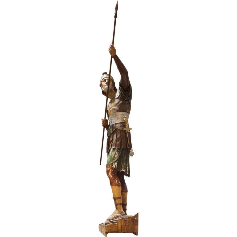 This Grand statue of a Roman soldier in a polychrome finish is from a large scene from Italy. You can see the cut from the original block of wood. Wonderful colors are present and detail. This is a very 