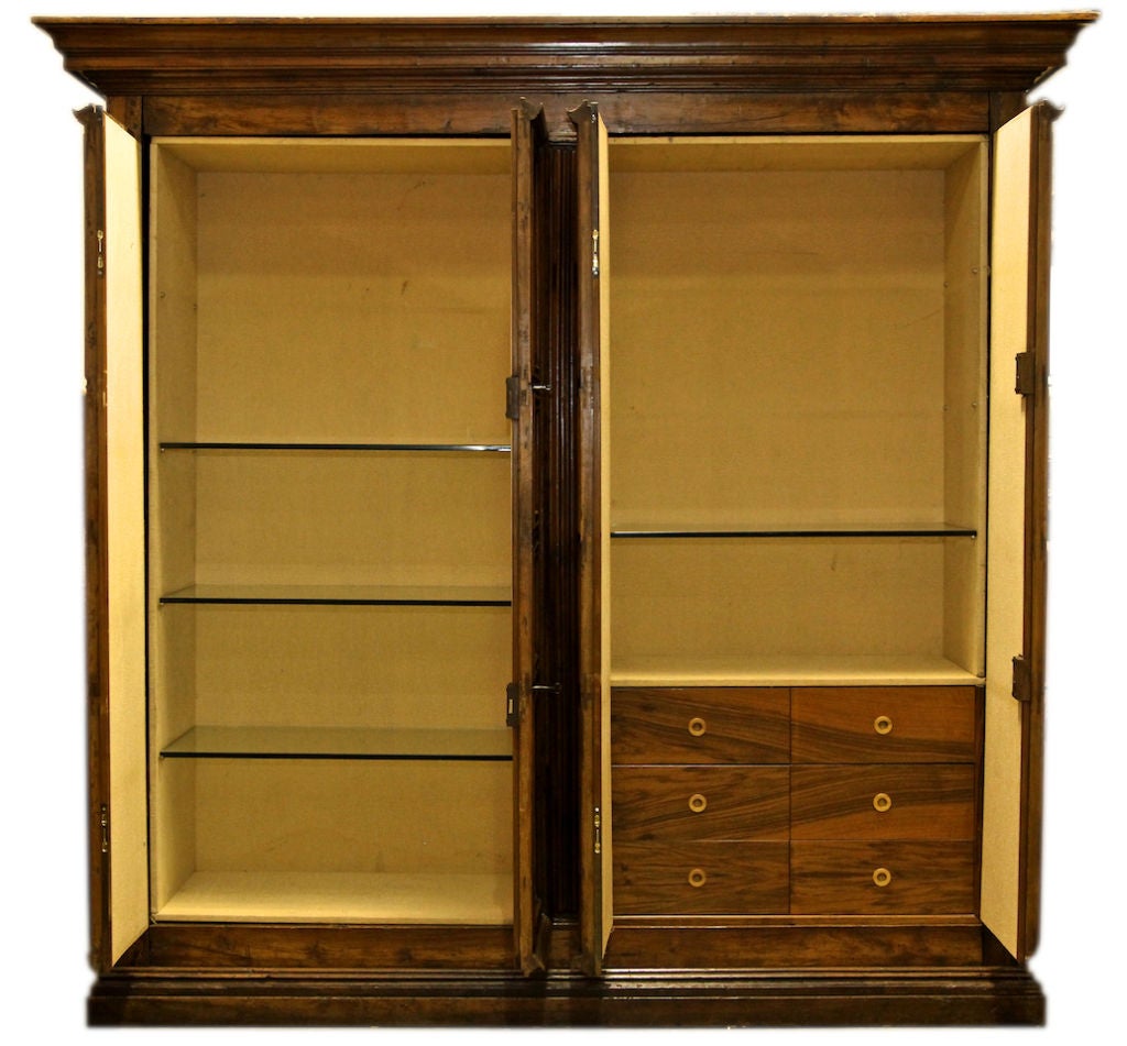 Massive proportions in the cabinet have a geometric structure and schematic with a molded projecting broken lines. Divided into two parts, the upper and enclosed by two pairs of doors with raised panels The decoration consists of vertical and