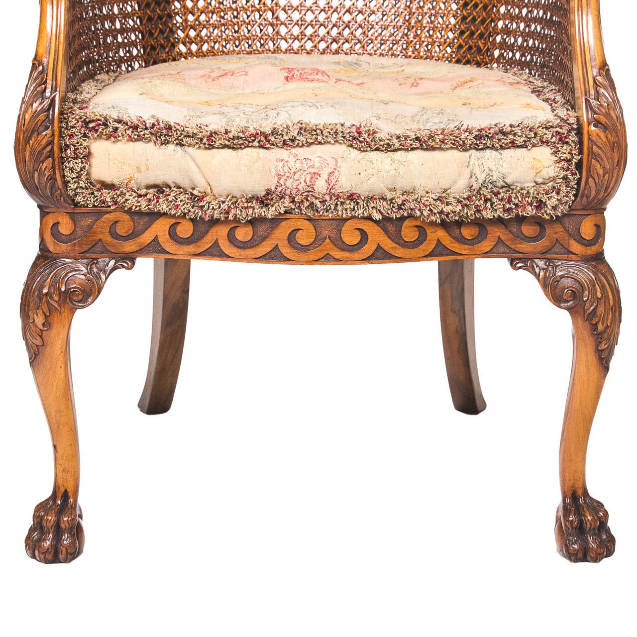 This is a grand pair of English walnut barrel back chairs with cane backs and seats. There is the original cushion fitted for seating. Superb color and finish to these chairs. The apron of these chairs are presented with an impressive vitruvian
