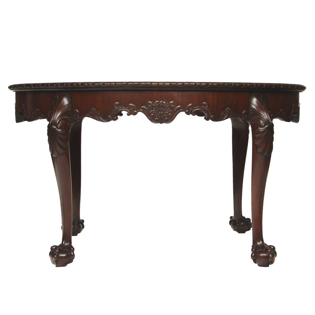 A handsome English Chippendale Mahogany oval center table from the 19th century. This table is a fine example of the Chippendale style. Beautiful flamed mahogany top and banded with crotch mahogany. There is a detailed and fine carved egg and dart