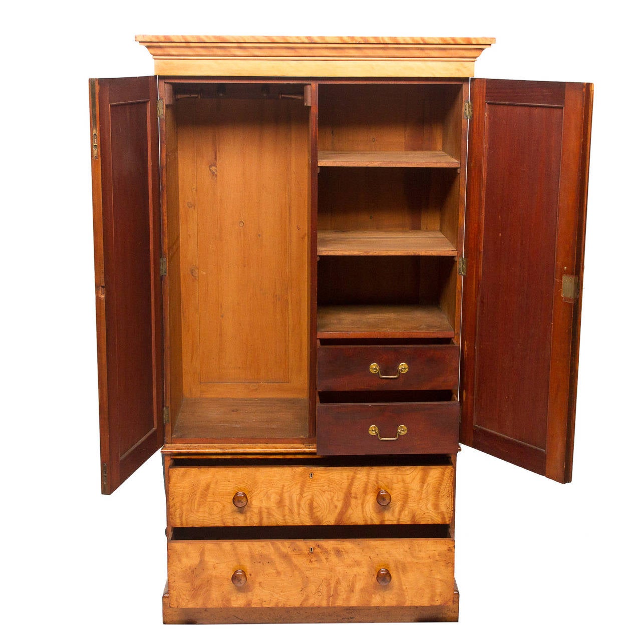 A fine example of artistry from the noted Heal and Sons of London. The figured satin birch shows the skillfulness and quality of work from this maker. Two doors open to a fitted interior. A side for hanging items then a divider and shelves and