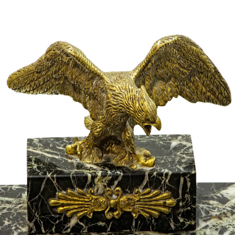 A fine 19th century French bronze and marble double inkwell with bronze eagle surmount. There are the two inkwells on either side with the glass containers and a concave cutout for writing instruments. The piece rests upon four ornate feet.