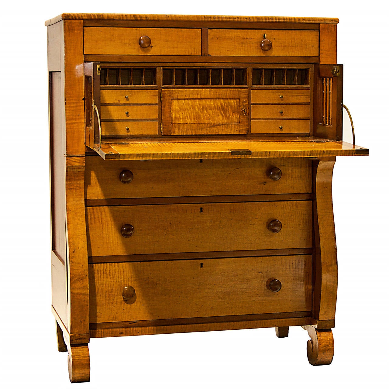 A 19th century American Empire maple and cherrywood chest with drop front secretaire drawer and fitted interior. The front is presented with tiger maple and cherrywood sides and top. This piece has wooden knobs and functions very well. Drawers slide