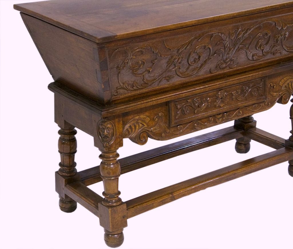 A Fantastic french provincial walnut petrin. Well carved and hinged lift top. Inside its lined with a zinc liner (was added). Dovetailed sides front and back. Pegged joints and one drawer in the center of the apron. Resting on turned legs and box