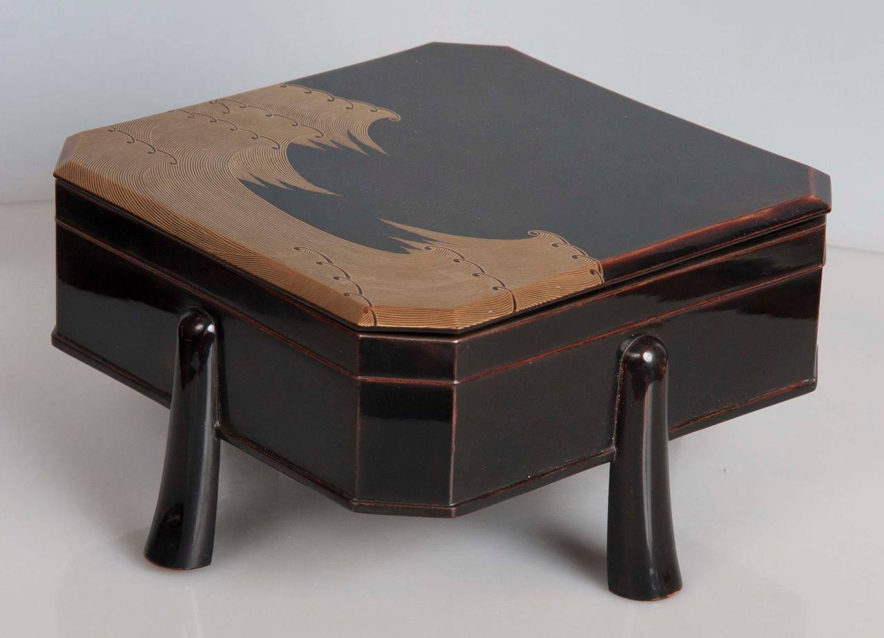 An unusual black lacquer and wave form motif Japanese box from the Meiji era with four middle side legs.