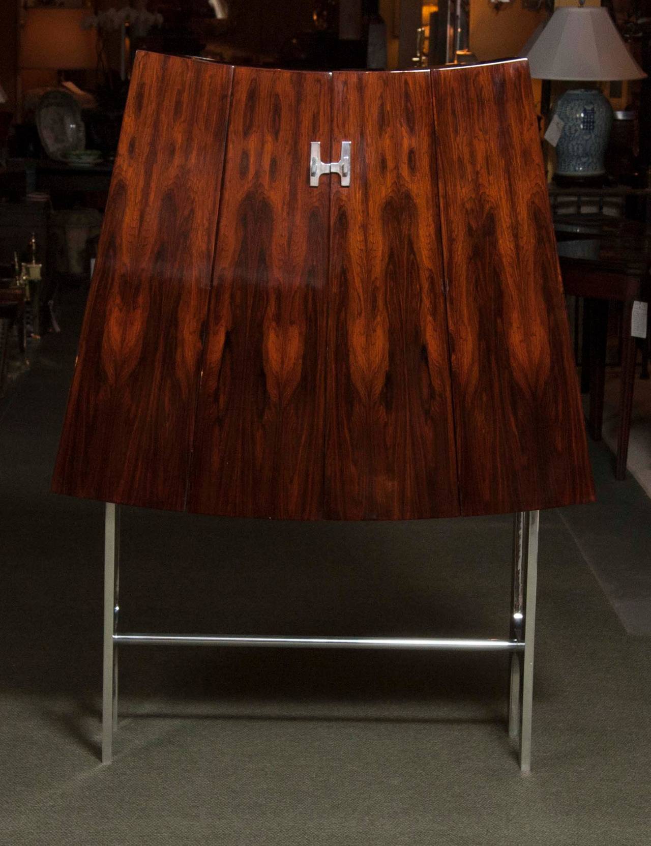 A fabulous pair of tapered rosewood cabinets on nickel-plated stands attributed to René Jean Caillette (1919-2004).
The son of a woodworker, Caillette always intended to follow in his father's footsteps, but not in exactly the same way. For him,