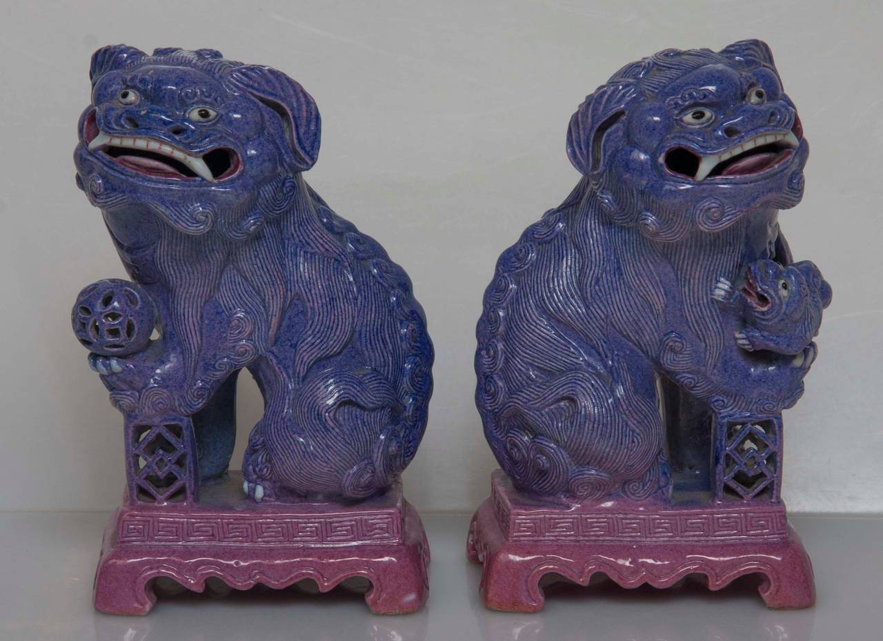 A pair of very finely made Chinese porcelain seated Foo Dogs with lilac glaze. 
Late Qing dynasty.