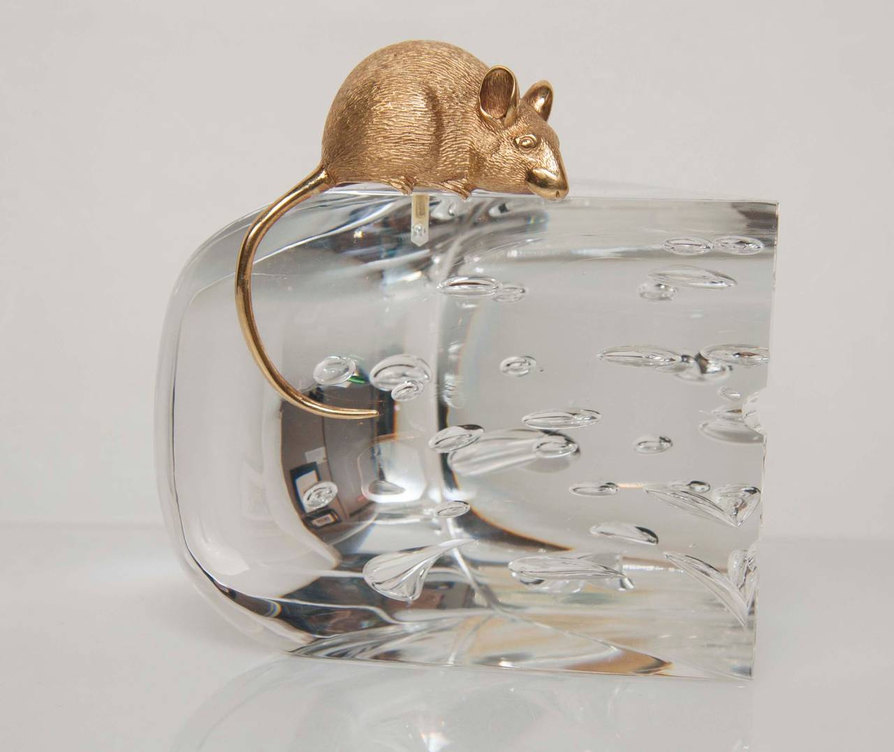 A whimsical Steuben cheese form glass Objet D'art surmounted with an 18-karat (tested) gold mouse.
