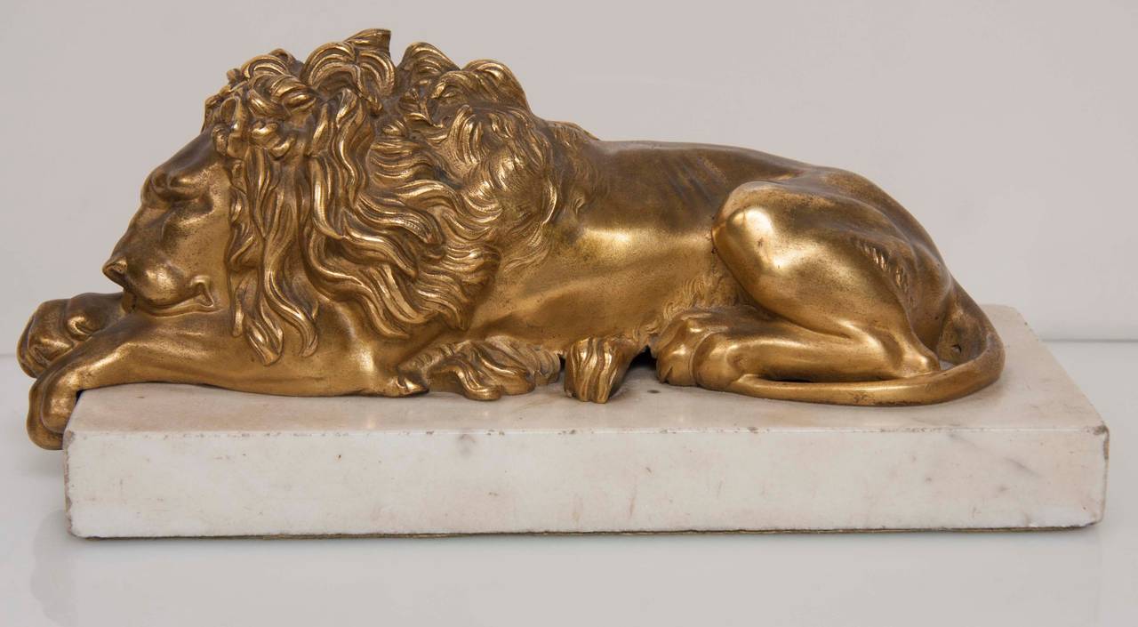 Gilt and Bronze Recumbent Lion Sculptures In Excellent Condition In Stamford, CT