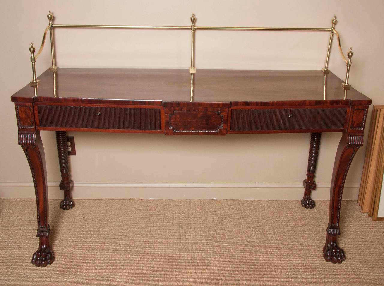 An English late Regency mahogany server with brass rail and wonderfully carved paw feet, 

Rail measures 51.5