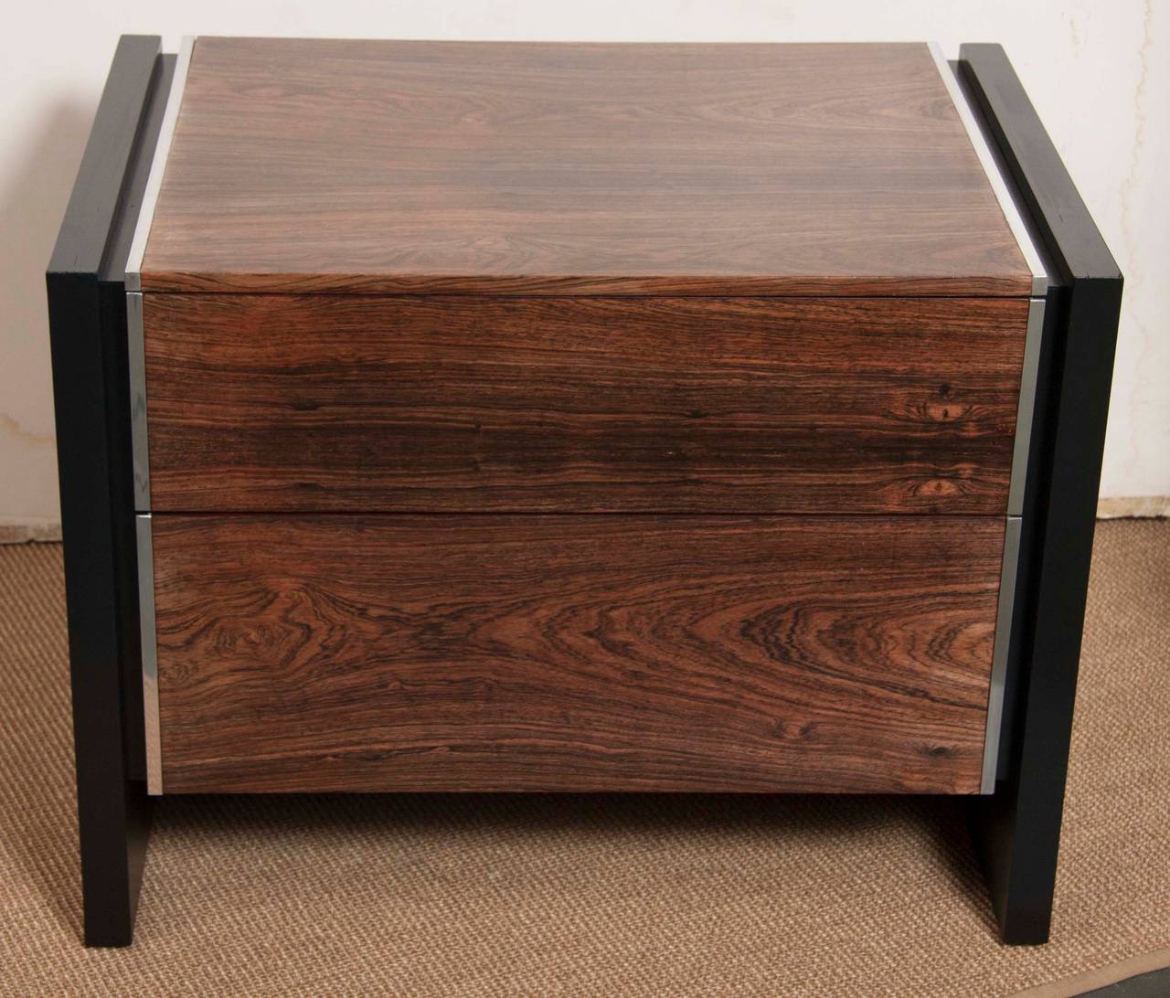A pair of sleek two-drawer, rosewood with black lacquered sides, nightstands by John Stuart of Grand Rapids, MI.