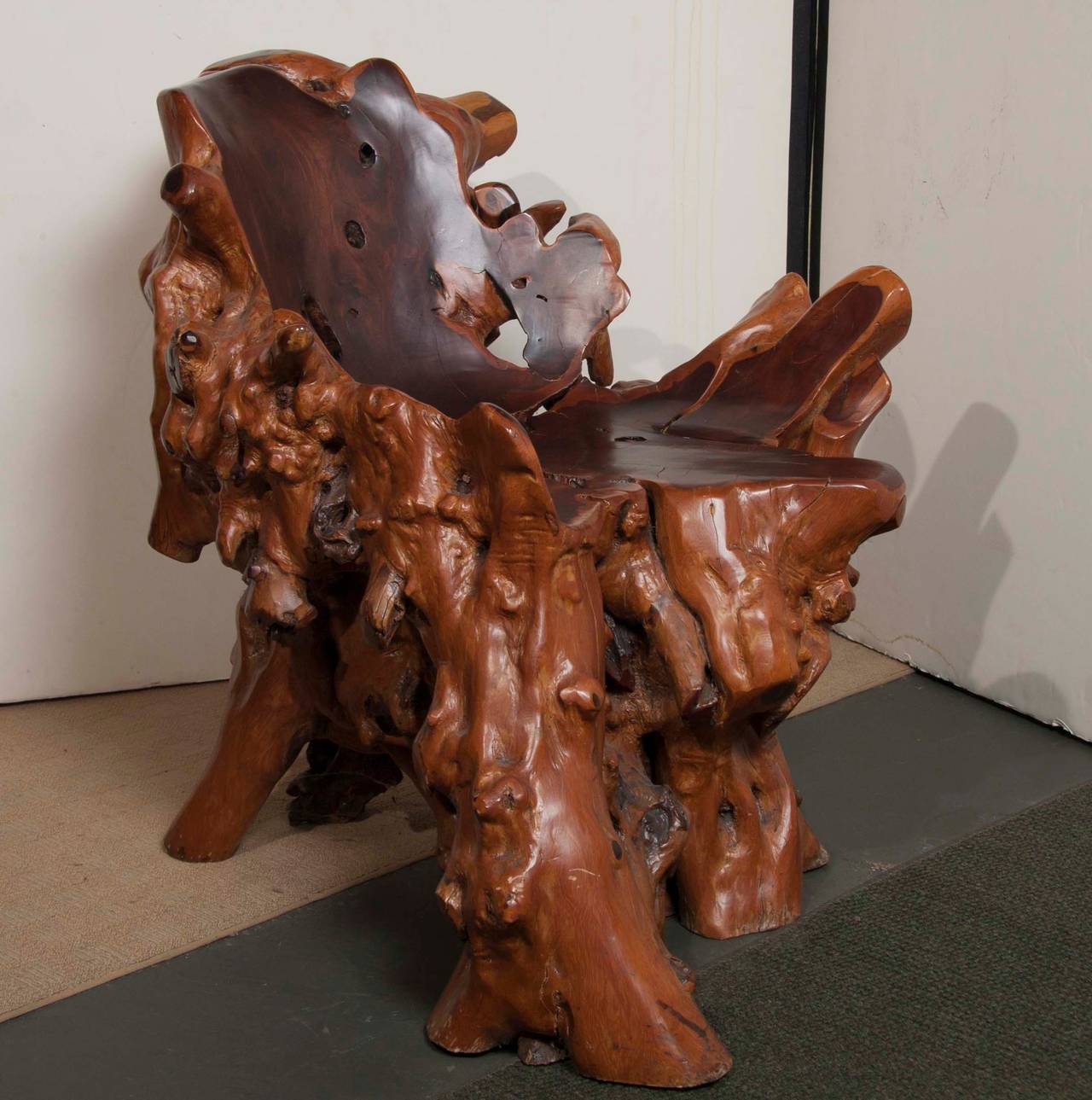 An Asian burled wood or root chair, formed in a naturalistic shape.