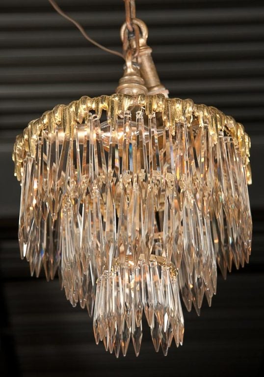 A wonderful set of two, French dore bronze, triple tier chandeliers retaining original mounts.