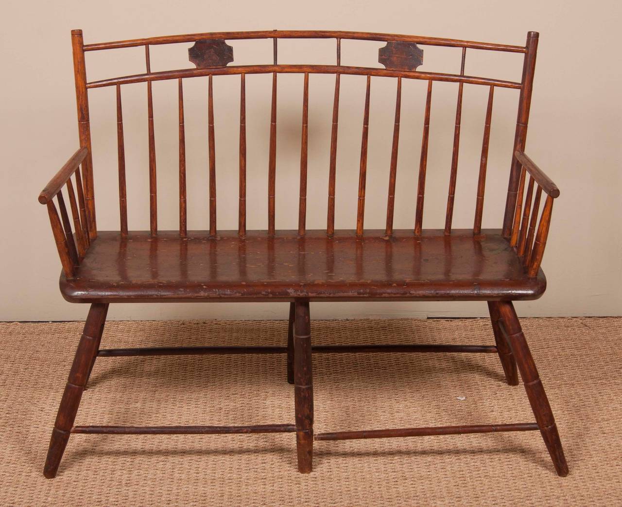 A 19th Century Windsor wooden (probably ash or hickory) settee of birdcage design from Pennsylvania.