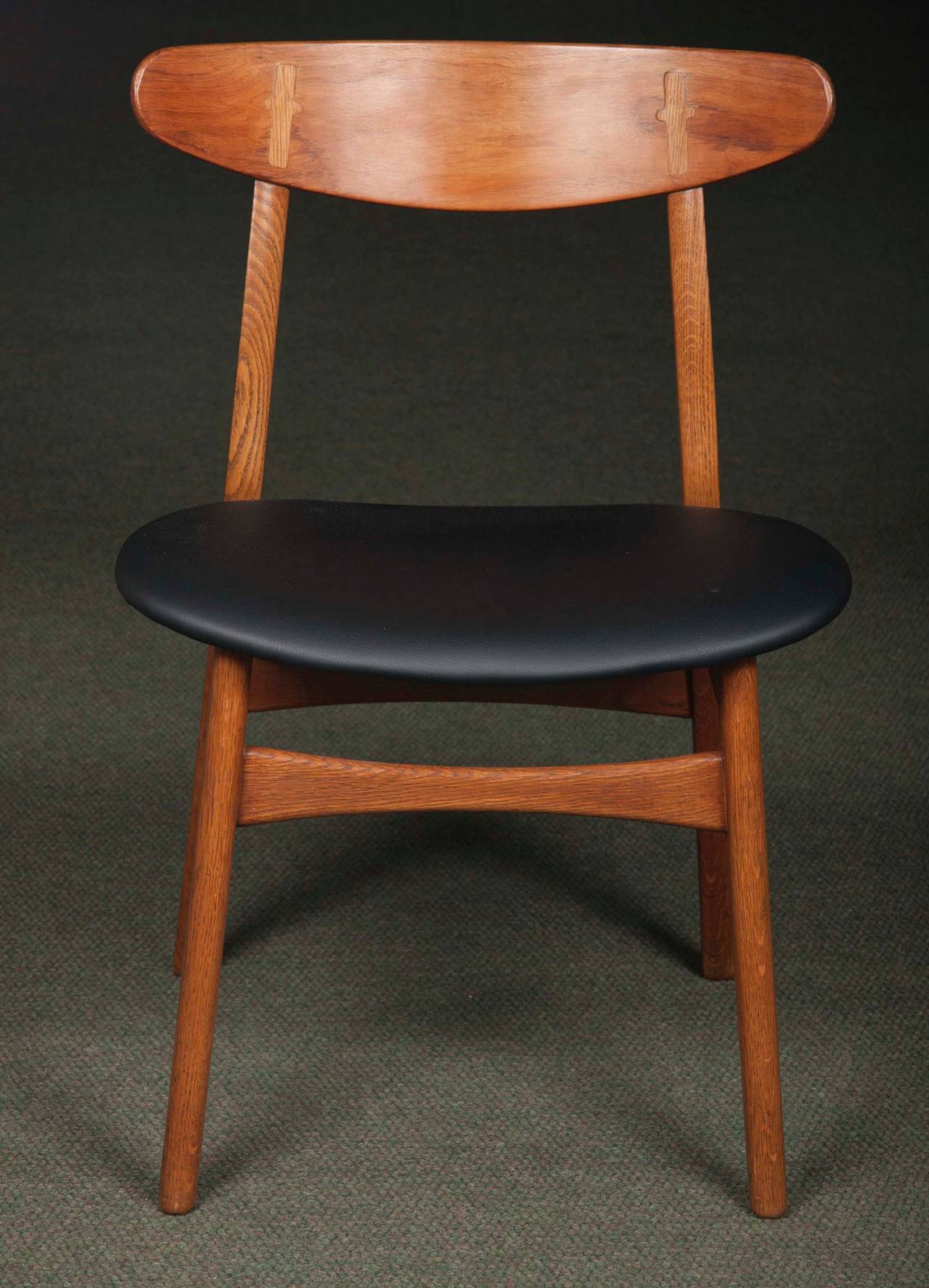 Set of ten Hans Wegner model CH 30 chairs having black leather seats.