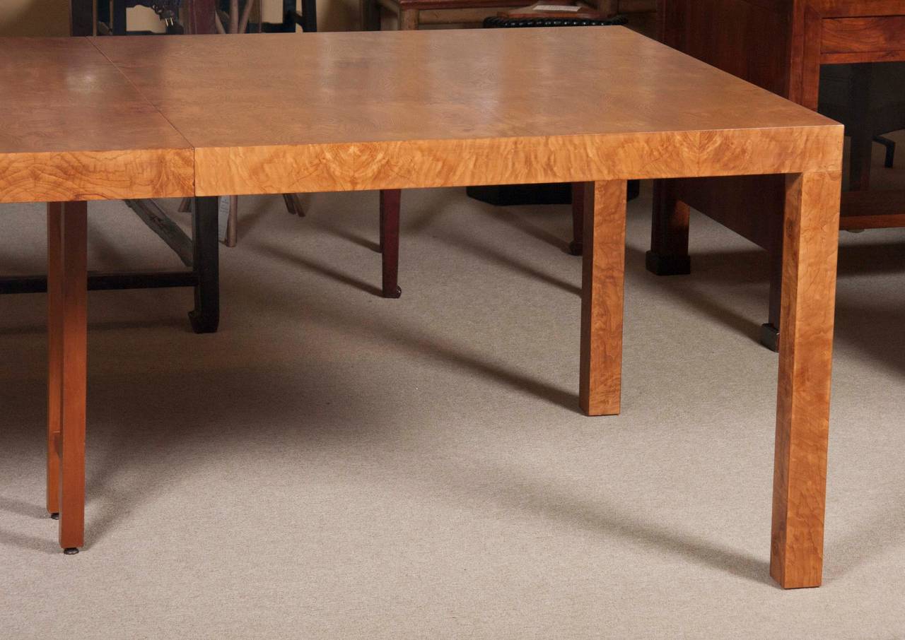 A Milo Baughman burl elmwood parsons dining table designed for Directional. The table has two 21
