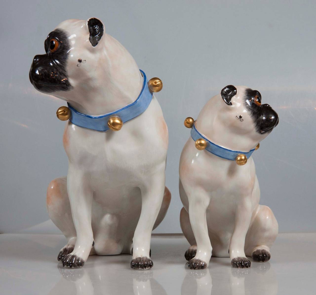A pair of fully hallmarked Meissen mother and pug dogs, after J. J. Kandler.
Small pug: 7" high x 7" wide x 4" deep.